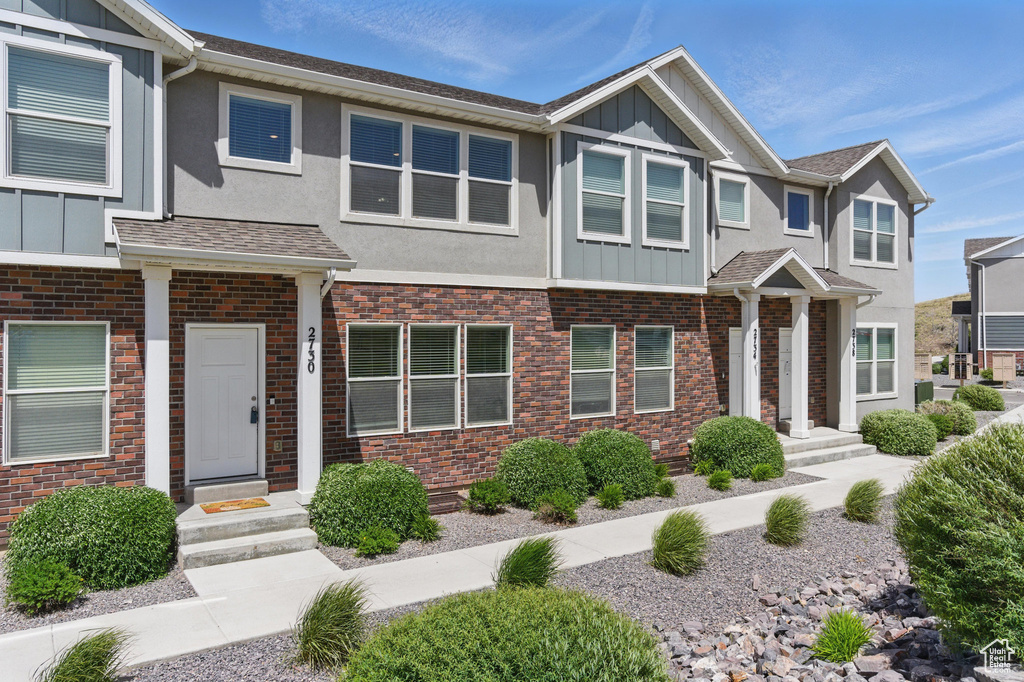 View of property with board and batten siding and stucco siding