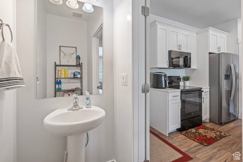 Bathroom featuring wood finished floors