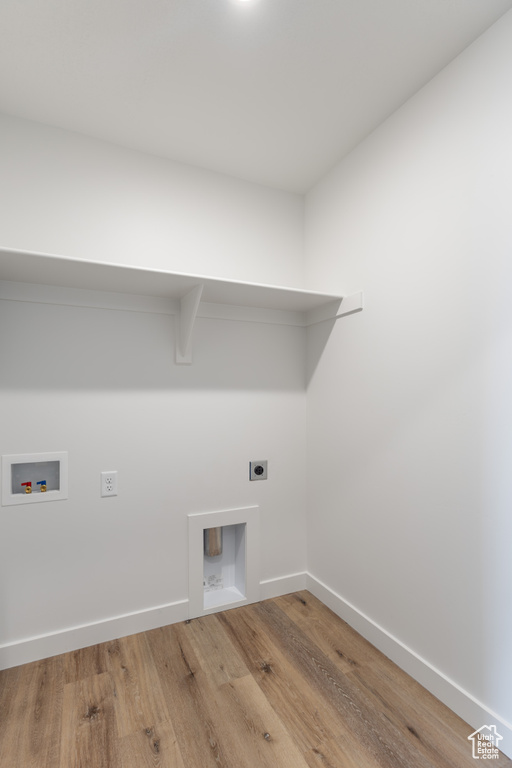 Laundry room with hookup for an electric dryer, wood finished floors, washer hookup, and baseboards