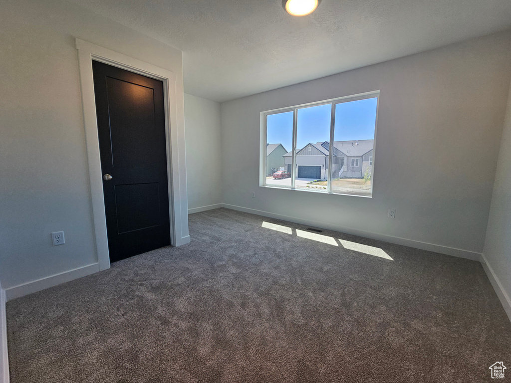 Unfurnished room with carpet floors and baseboards