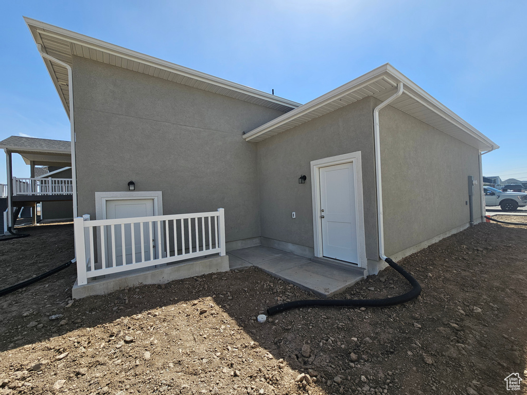 Back of property featuring stucco siding