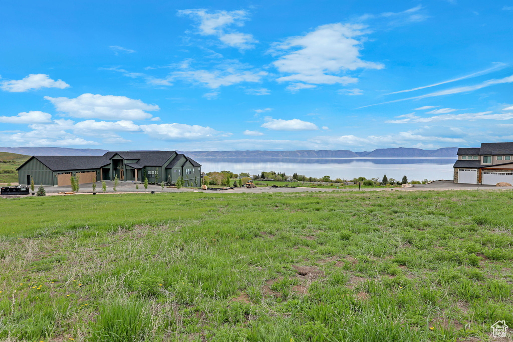 View of yard featuring a water and mountain view