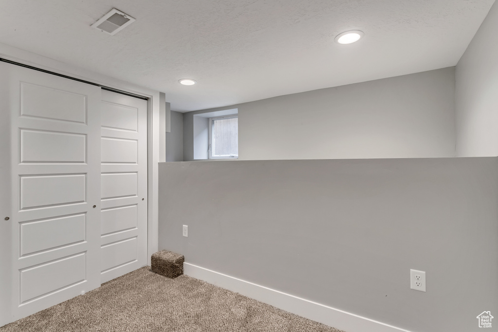 Interior space with baseboards, visible vents, carpet floors, and recessed lighting