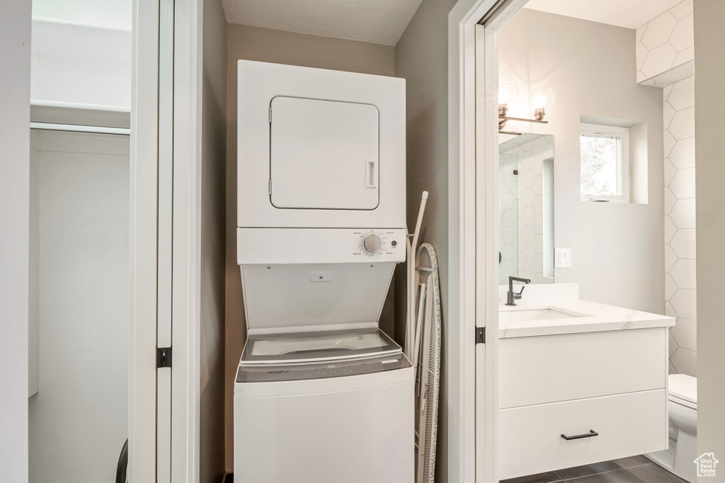 Laundry area with estacked washer and dryer