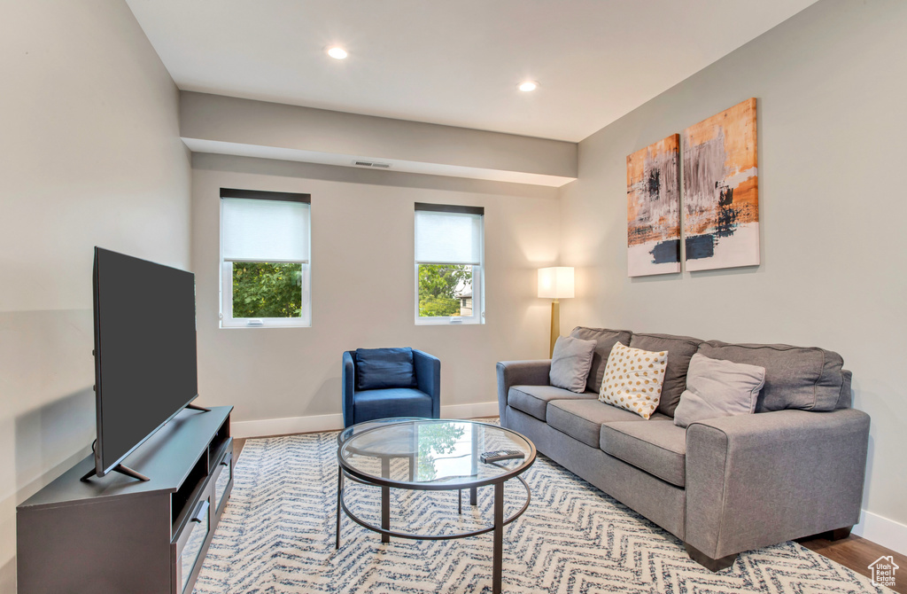 Living room with baseboards, recessed lighting, and wood finished floors