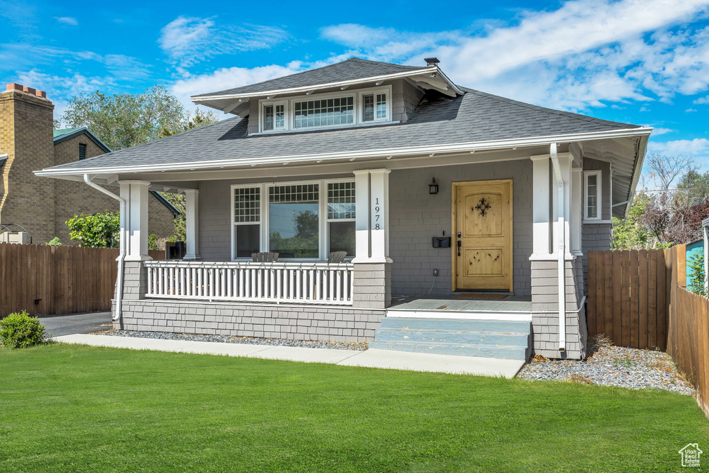 Bungalow with roof with shingles and covered porch