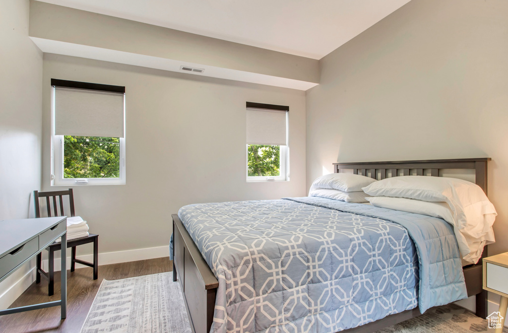 Bedroom featuring wood finished floors and baseboards