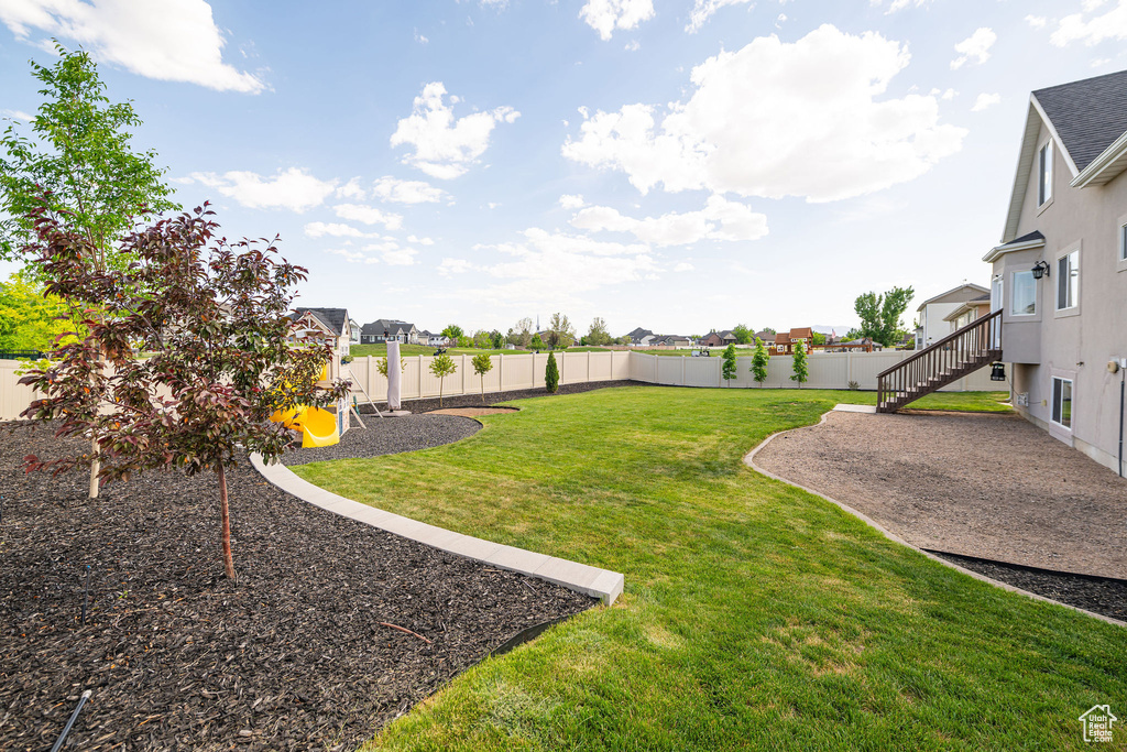 View of yard with a playground, a residential view, a patio area, and stairs