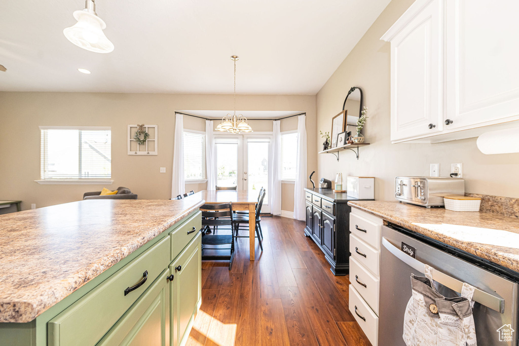 Kitchen featuring stainless steel dishwasher, green cabinets, white cabinetry, dark wood-type flooring, and light countertops