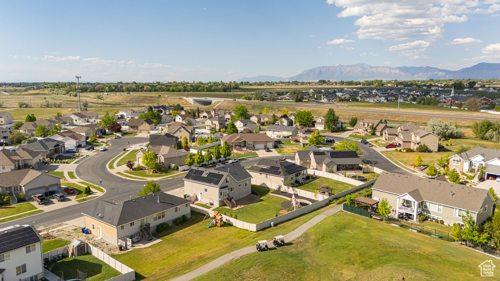 Aerial view of residential area featuring a mountainous background