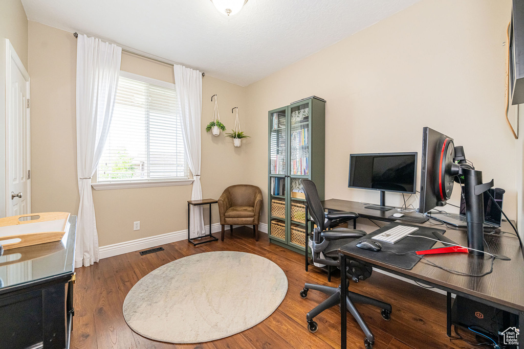 Office space featuring baseboards and wood finished floors