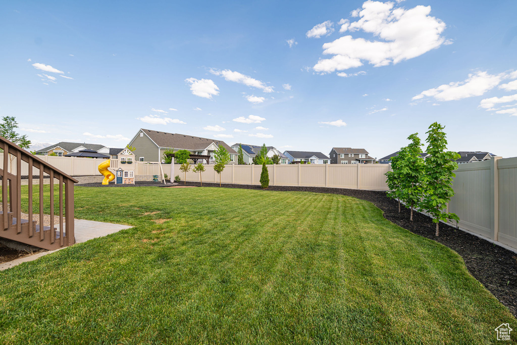 View of yard with a playground and a residential view