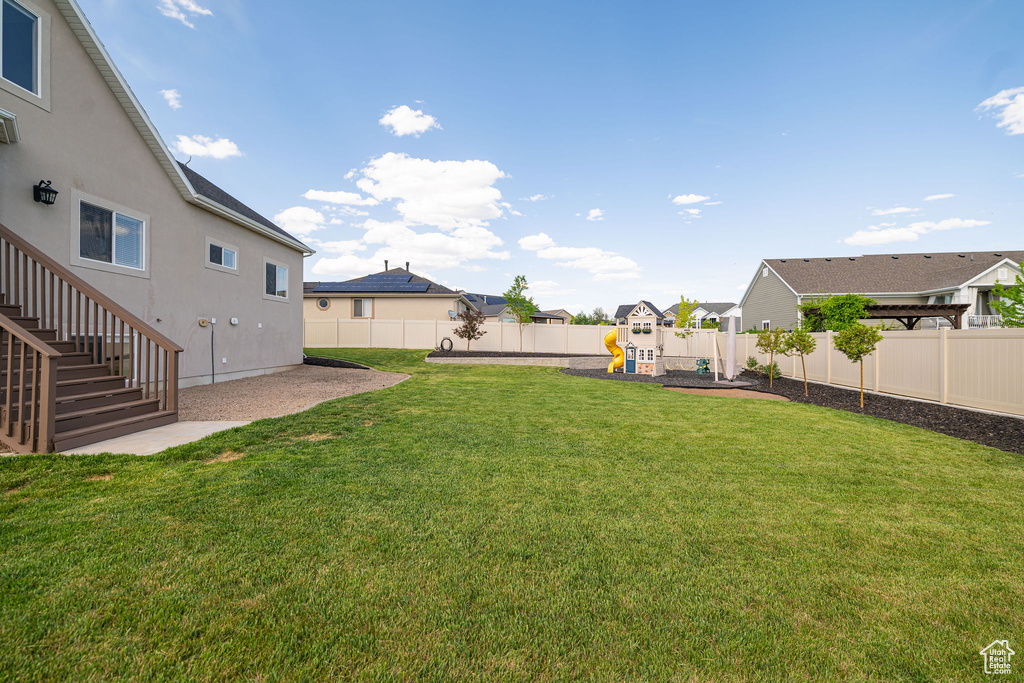 View of yard featuring a playground, stairway, and a residential view