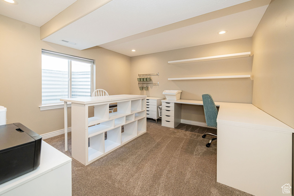 Office with dark carpet, recessed lighting, baseboards, and built in desk