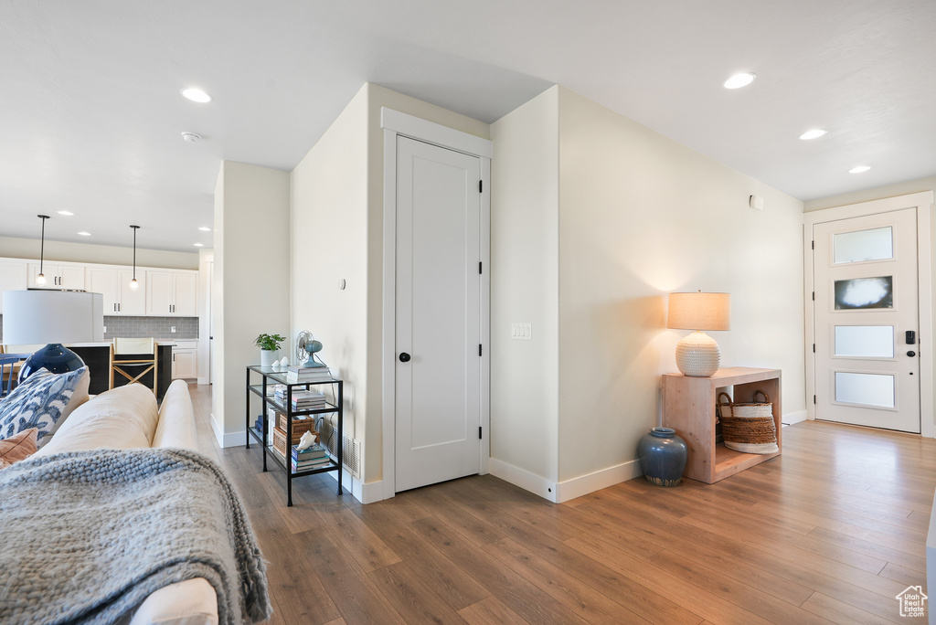 Living room featuring wood finished floors, recessed lighting, and baseboards