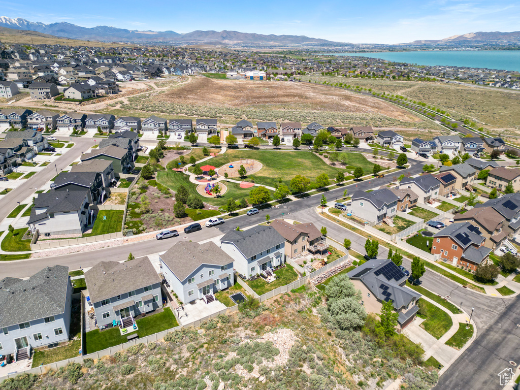 Aerial overview of property\'s location with a water and mountain view and nearby suburban area