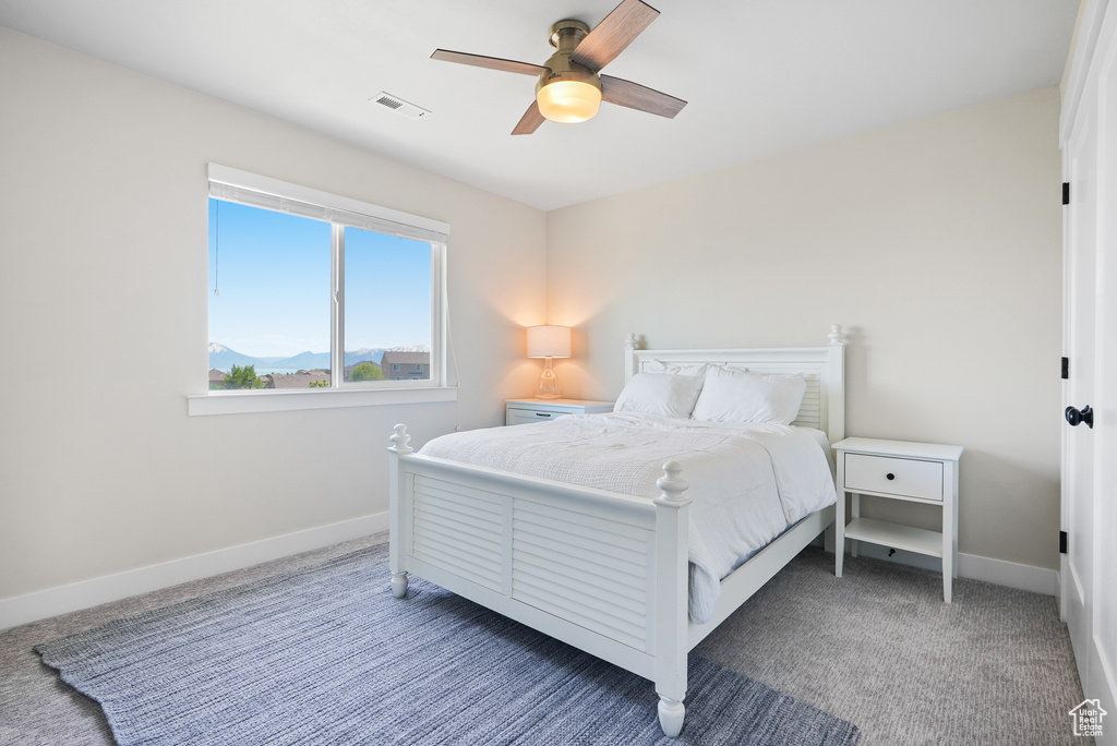 Bedroom with baseboards, carpet, and ceiling fan