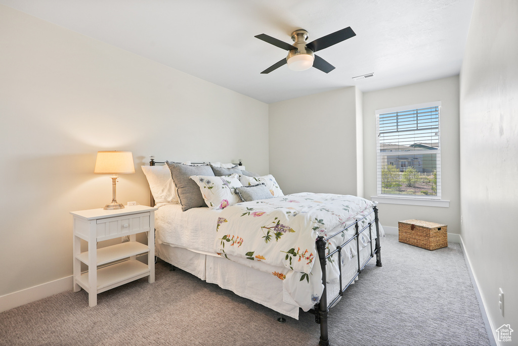 Bedroom with carpet, baseboards, and ceiling fan