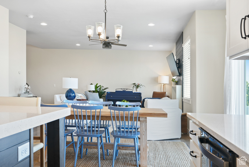 Dining room featuring a chandelier, recessed lighting, and wood finished floors