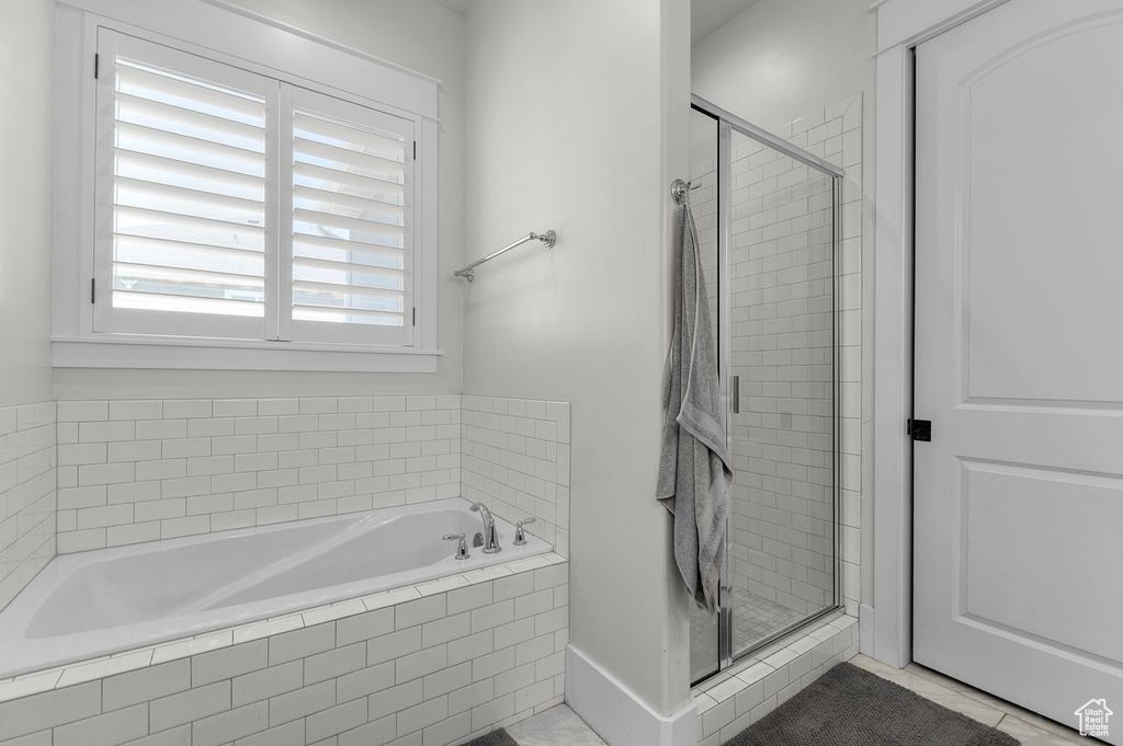 Full bathroom featuring a shower stall, tile patterned floors, and a garden tub