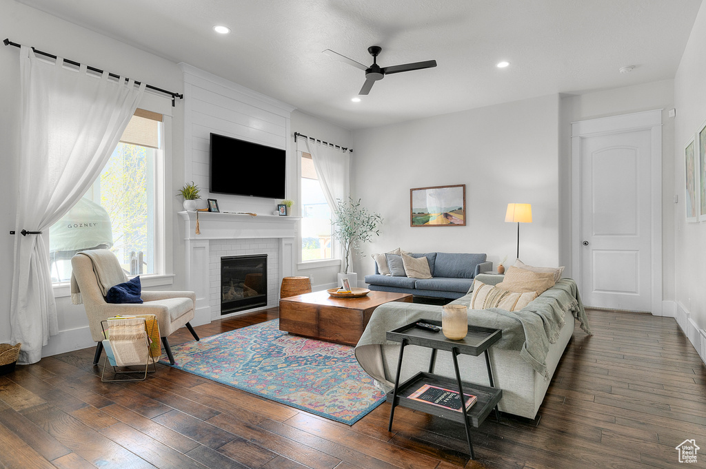 Living area featuring a ceiling fan, plenty of natural light, recessed lighting, wood-type flooring, and a fireplace
