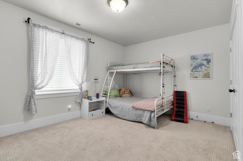 Bedroom featuring carpet flooring and baseboards