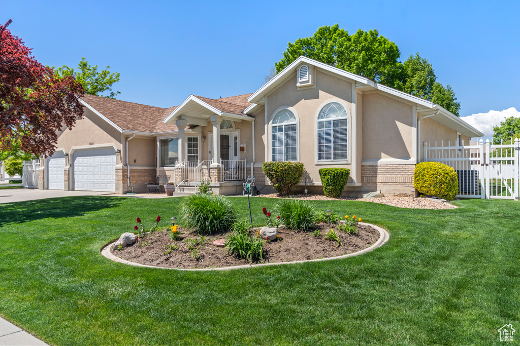Ranch-style house with a porch, stucco siding, an attached garage, driveway, and a gate