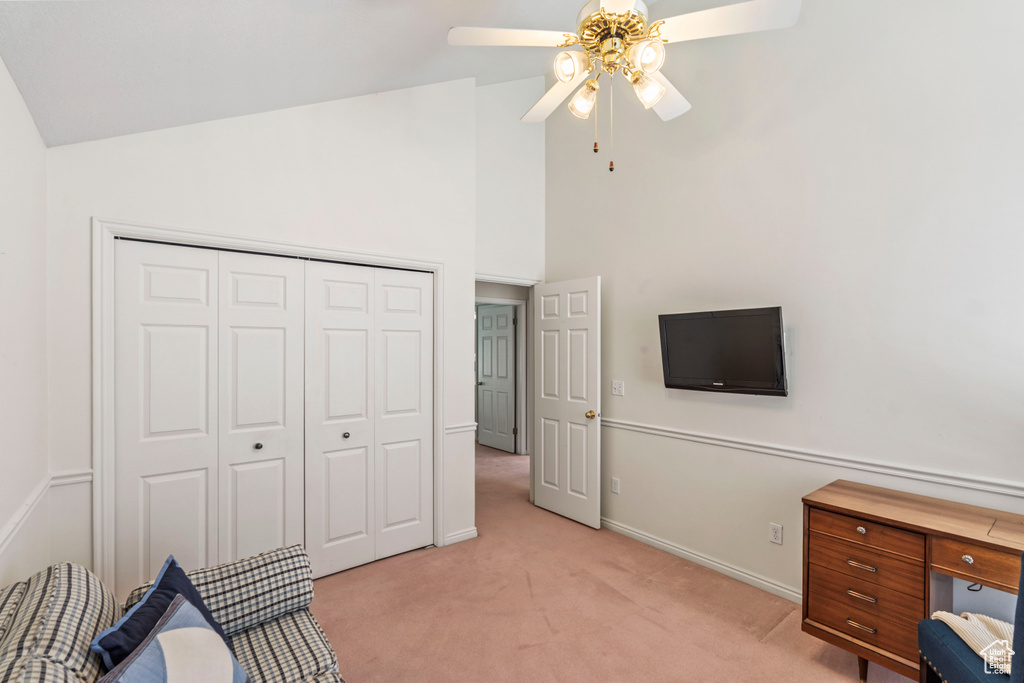 Unfurnished office with light carpet, ceiling fan, vaulted ceiling, and baseboards