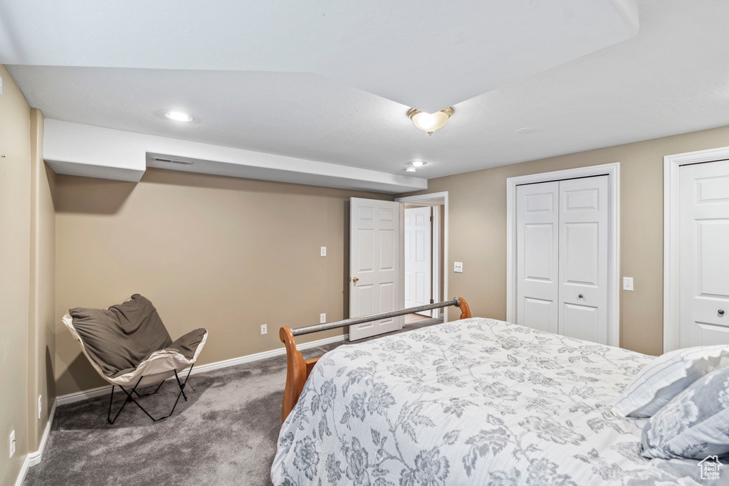 Bedroom with carpet floors, multiple closets, baseboards, and recessed lighting