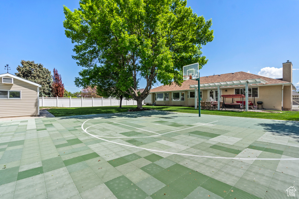 View of basketball court featuring community basketball court and fence