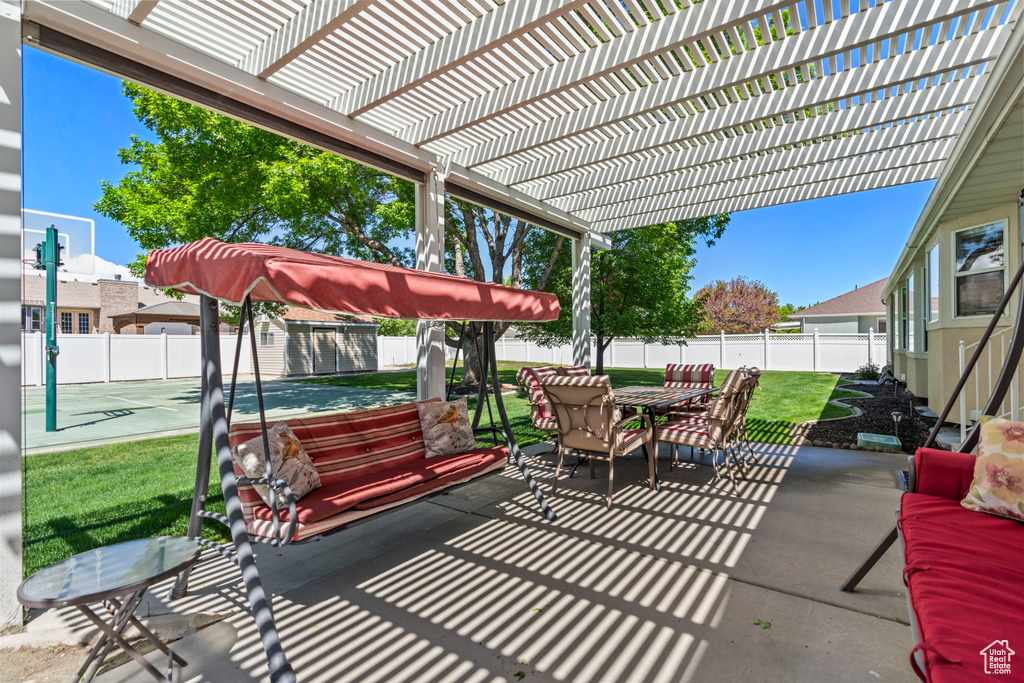 View of patio featuring a pergola, outdoor dining space, and shuffleboard