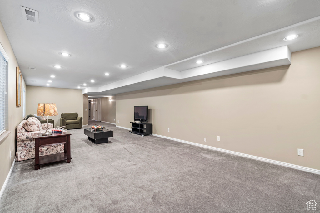 Carpeted living area featuring baseboards and recessed lighting