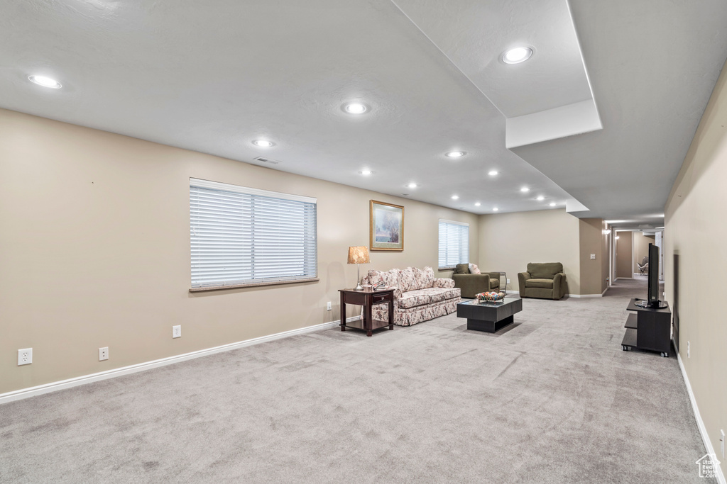Living room featuring carpet flooring, baseboards, and recessed lighting