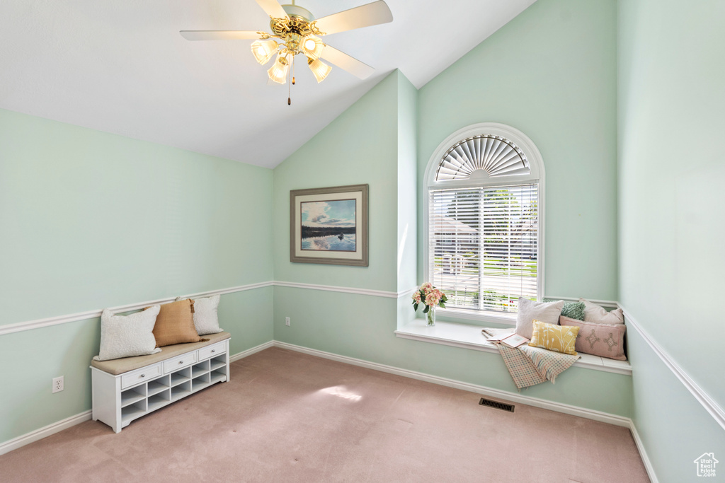 Sitting room featuring carpet floors, ceiling fan, baseboards, and high vaulted ceiling