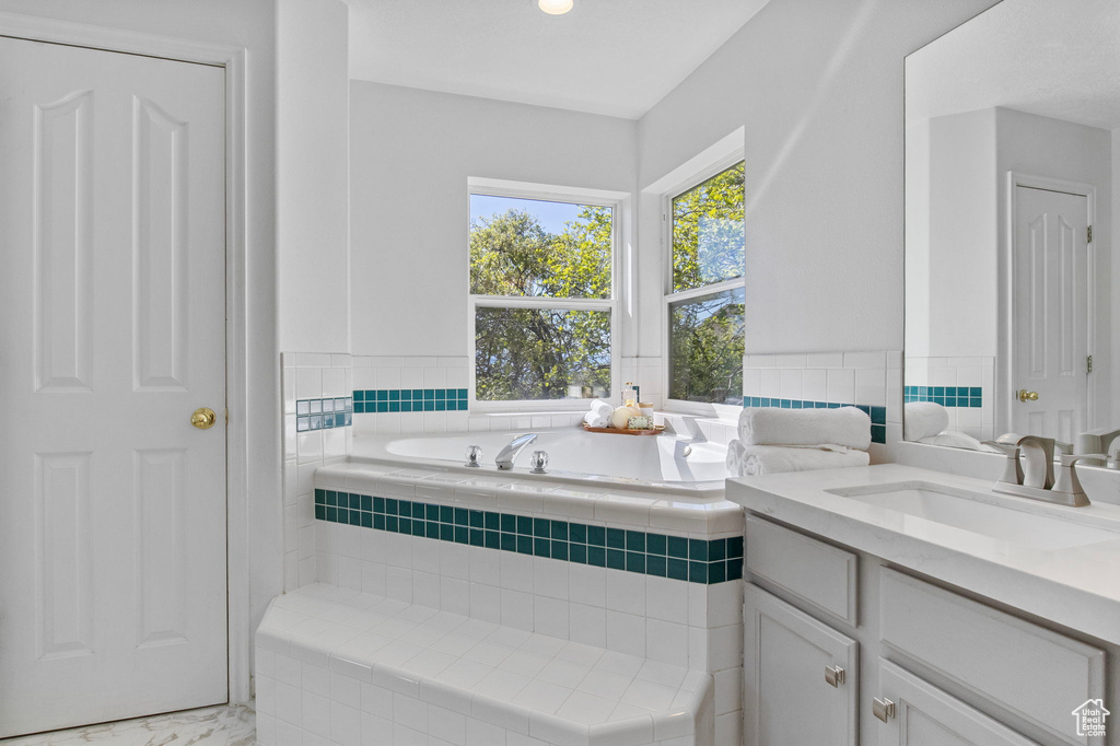 Full bath with a bath and vanity
