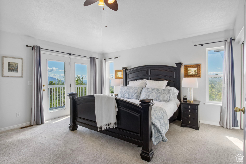 Bedroom featuring access to exterior, carpet, and baseboards