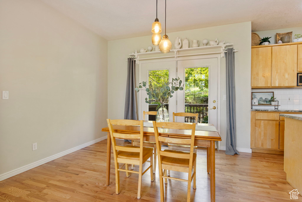 Dining room featuring light wood finished floors and baseboards