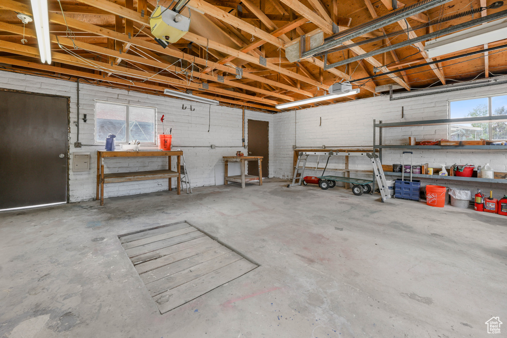Garage featuring a garage door opener and a workshop area