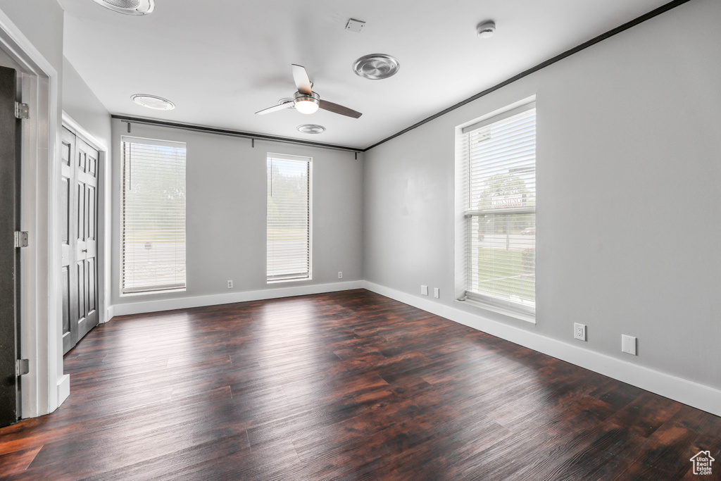 Interior space with baseboards, a ceiling fan, and wood finished floors