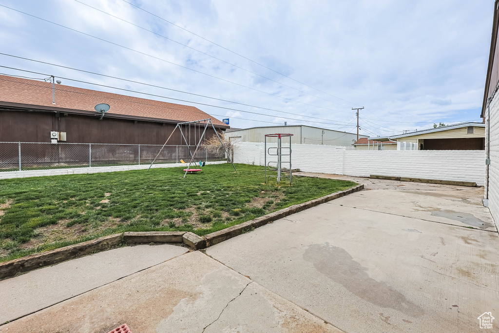 View of yard featuring a fenced backyard and a patio