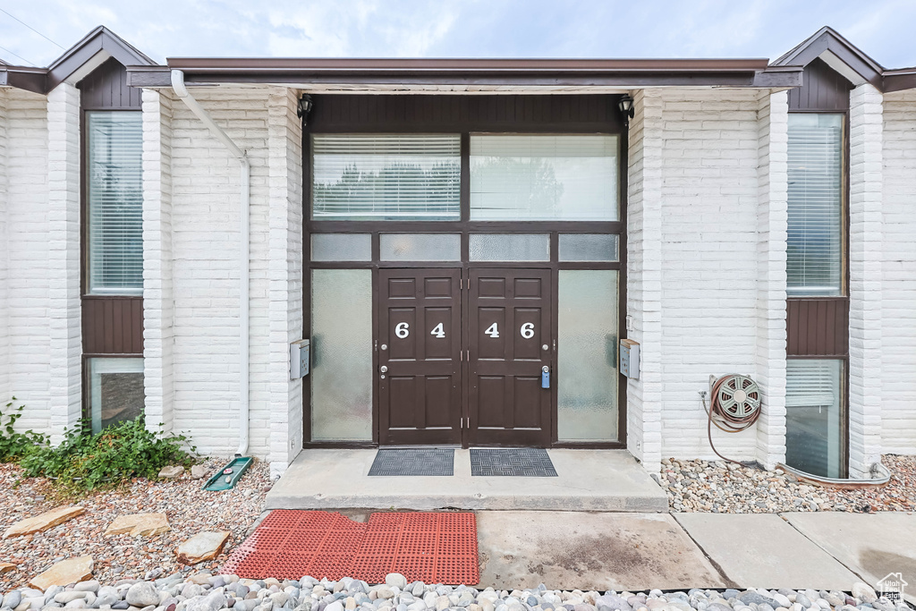 Doorway to property with brick siding