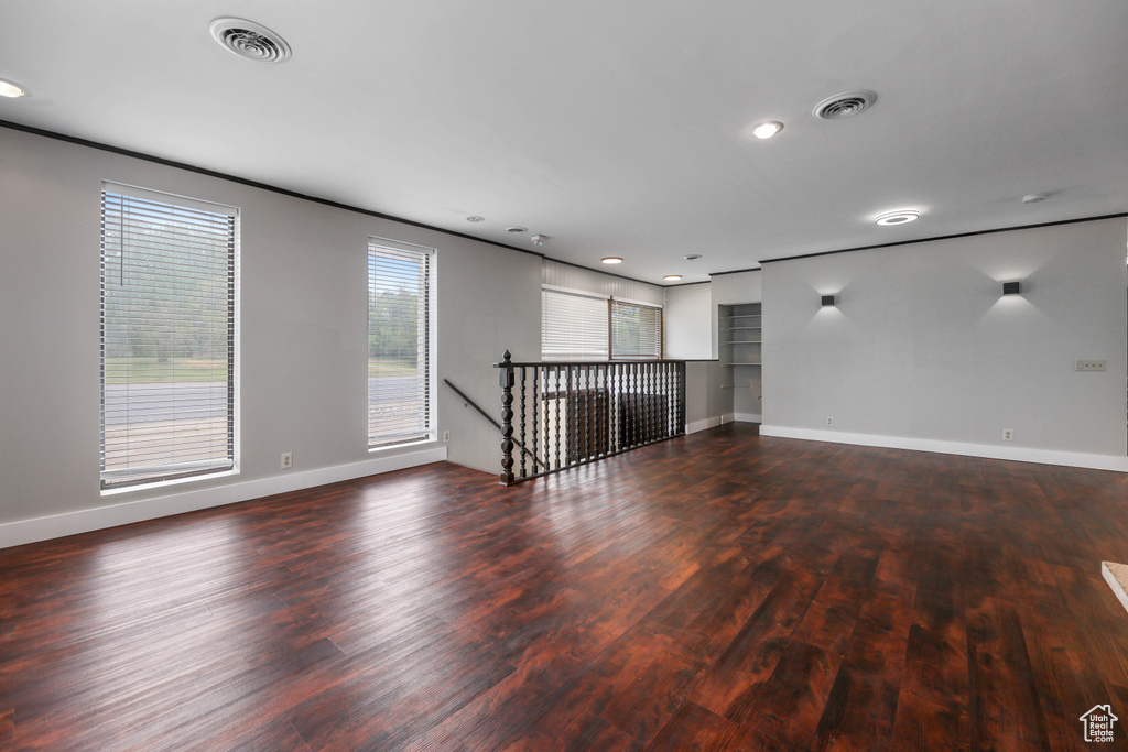 Unfurnished living room featuring baseboards, recessed lighting, wood finished floors, and visible vents