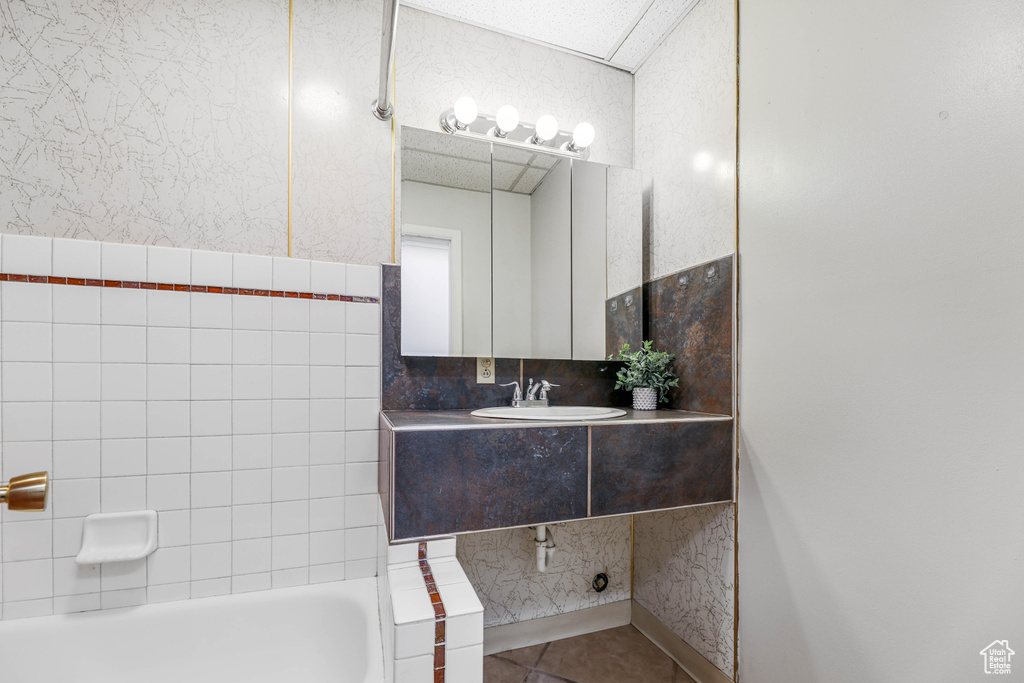 Full bath with vanity and tile patterned flooring