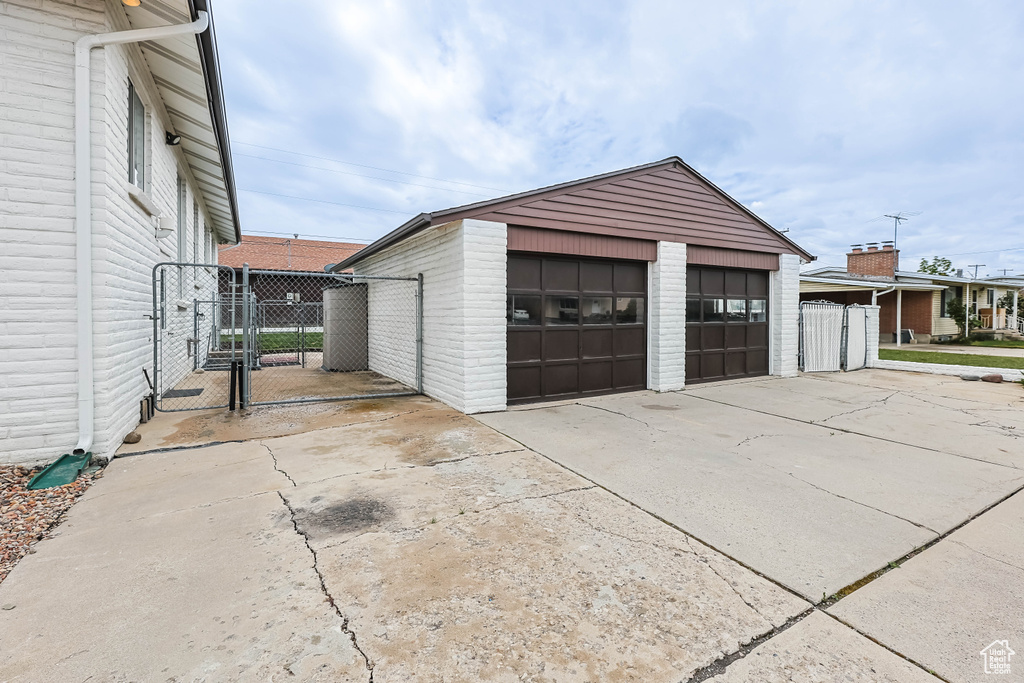 Detached garage featuring fence and a gate