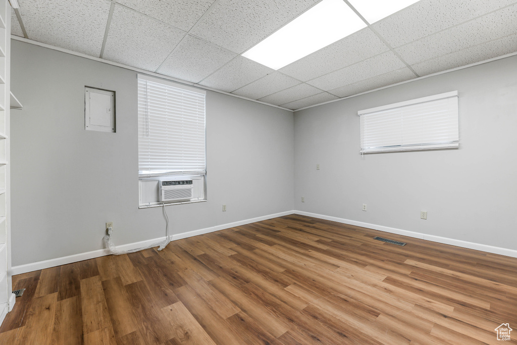 Empty room with baseboards, cooling unit, a paneled ceiling, and visible vents