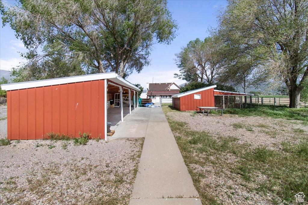 View of side of property featuring an outdoor structure, an exterior structure, and board and batten siding