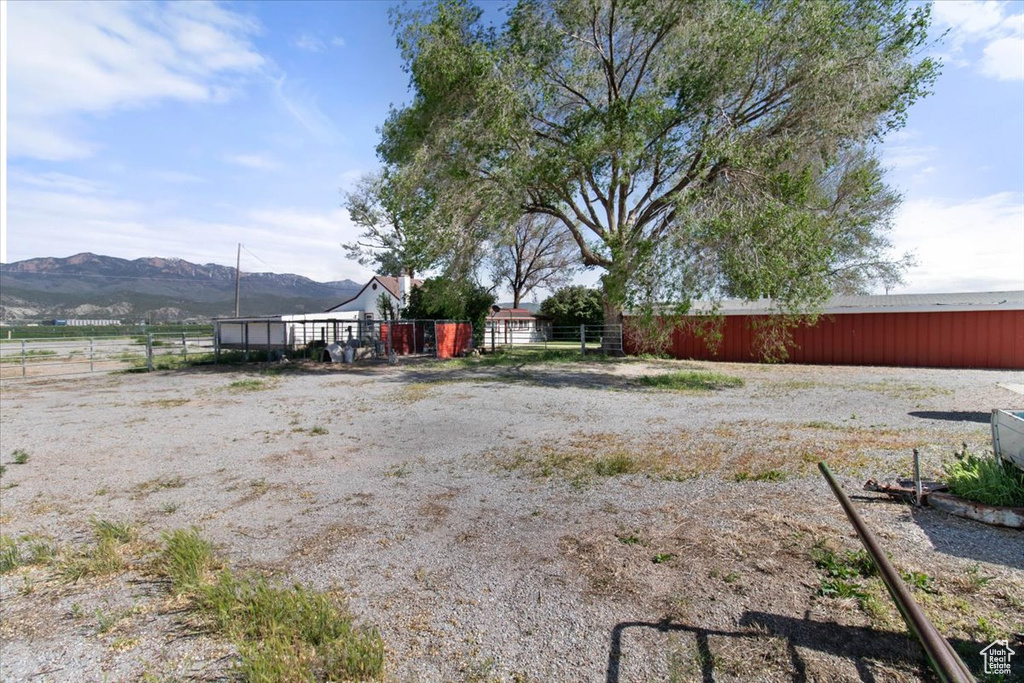 View of yard featuring a mountain view and fence