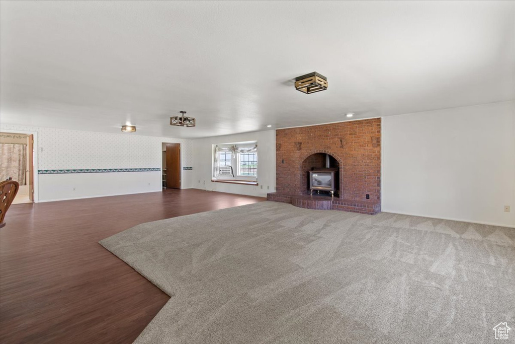 Unfurnished living room with wallpapered walls and wood finished floors
