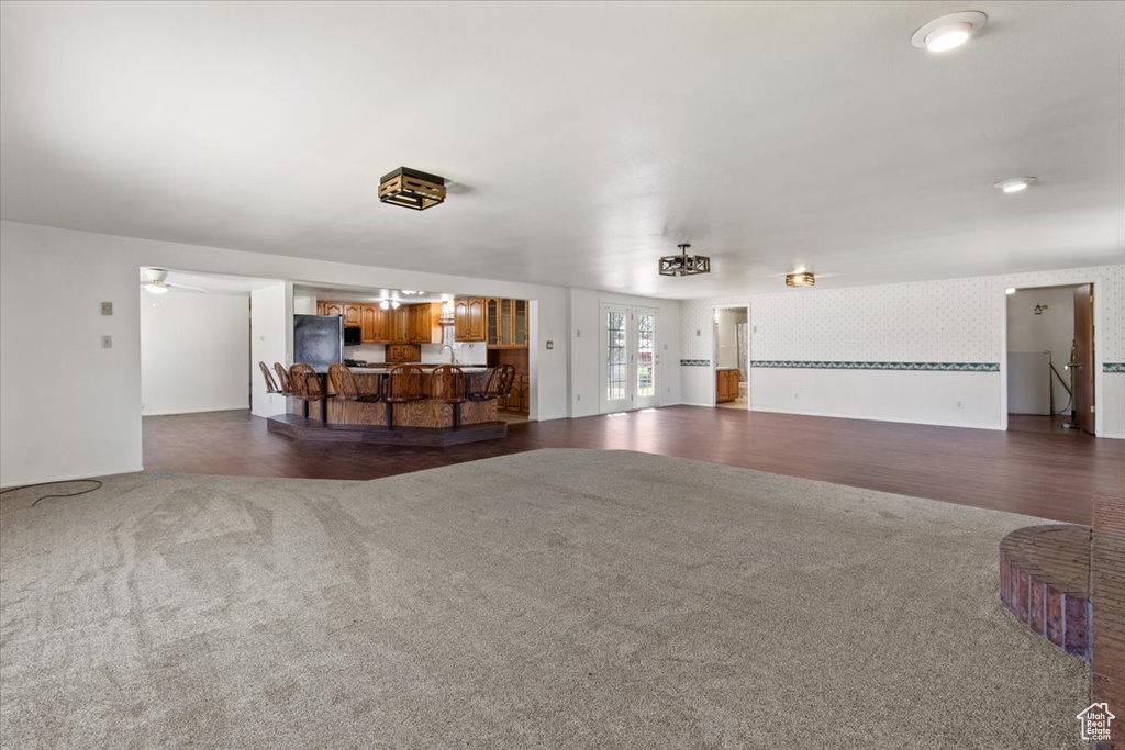 Living area featuring dark colored carpet