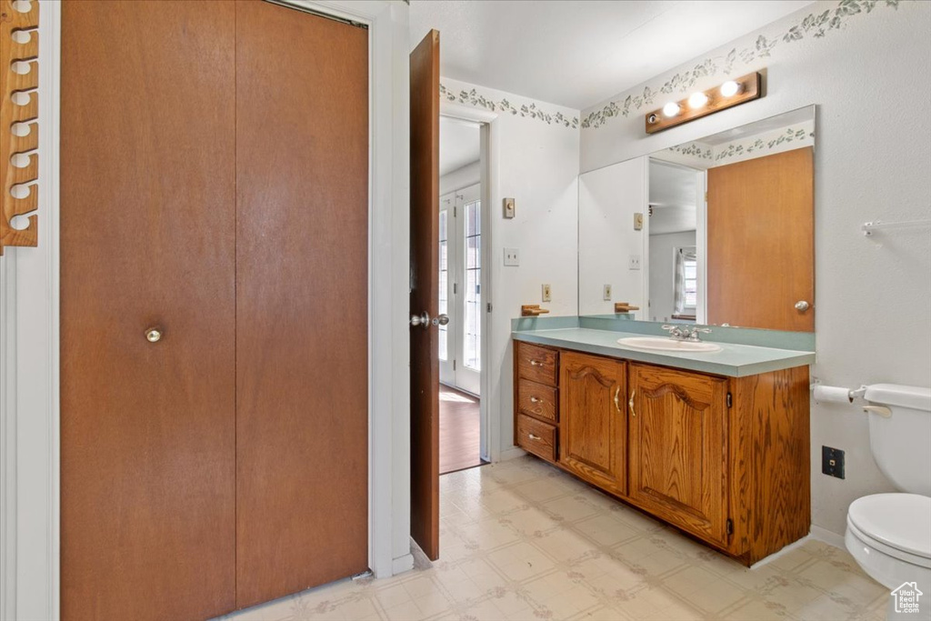 Bathroom with tile patterned floors, toilet, and vanity